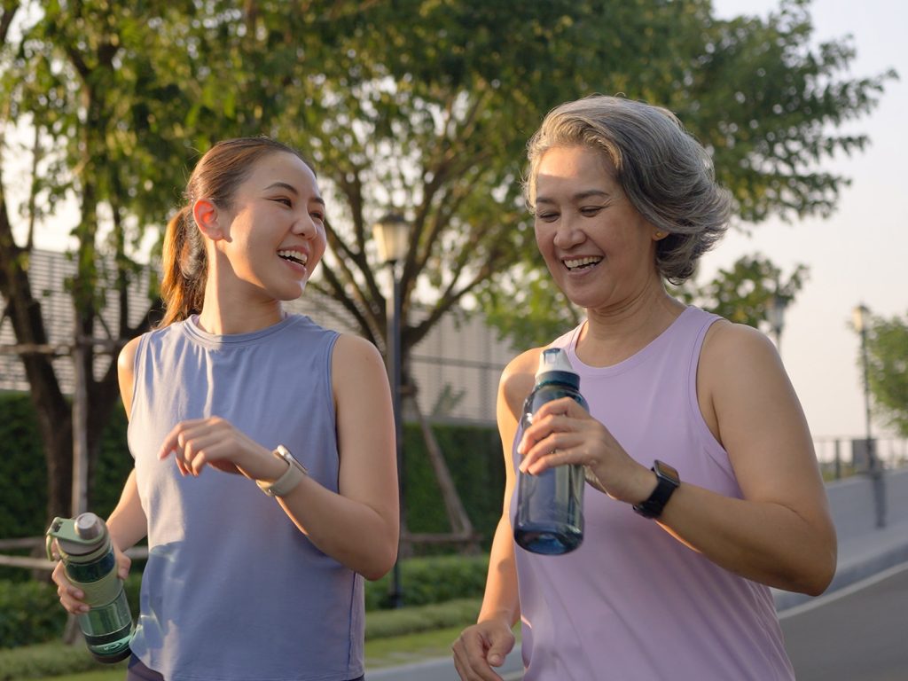 Two women walking with drink bottles