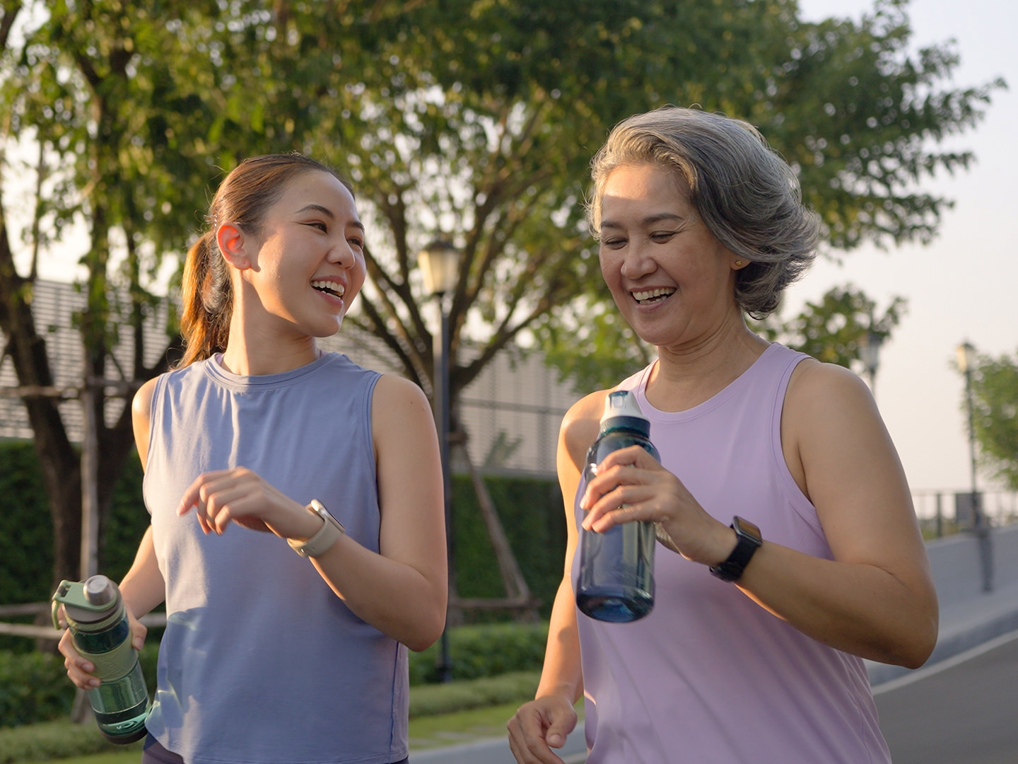 Two women walking with drink bottles