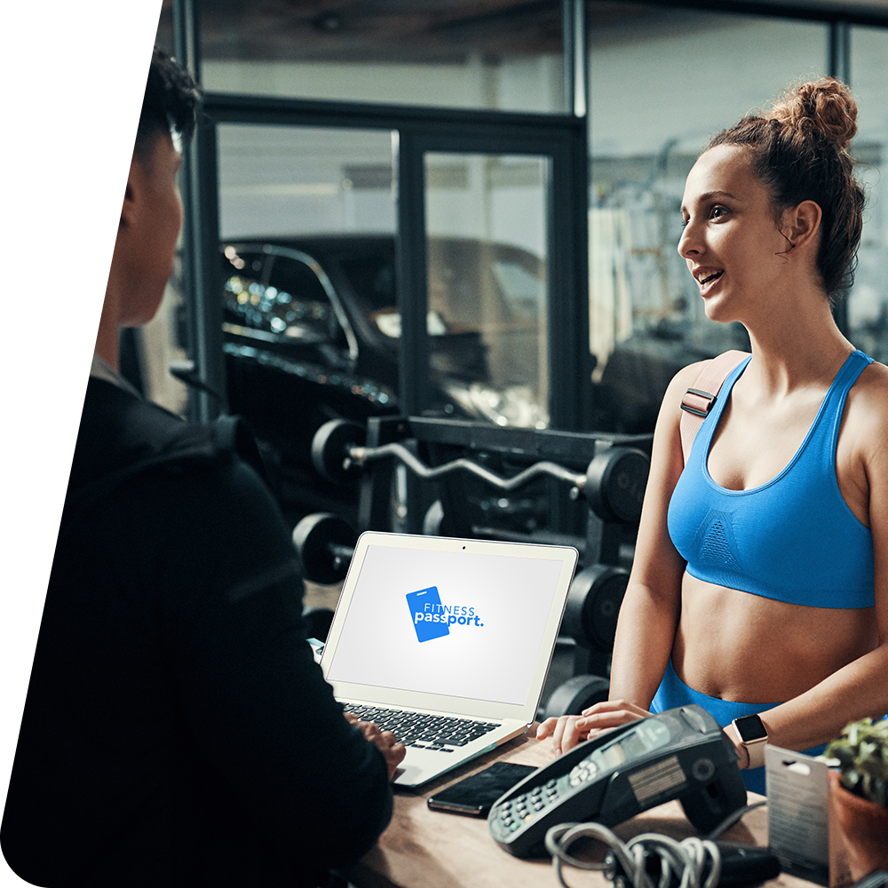 Woman talking to gym staff at front desk